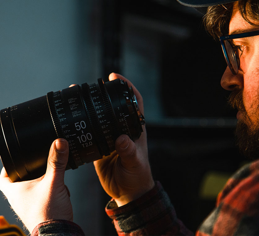 Man Inspecting Camera Lens